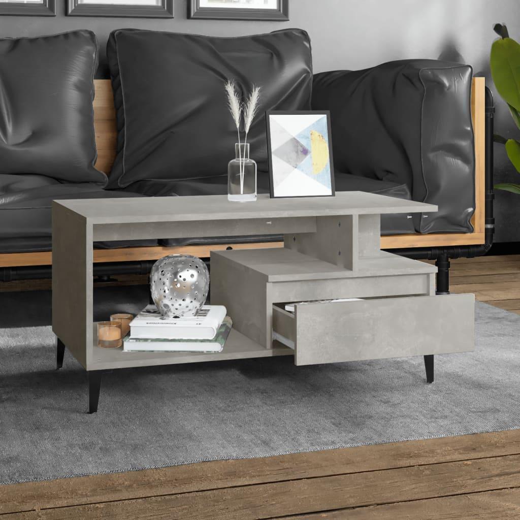 Modern grey concrete-look coffee table with open shelf, drawer and decor in stylish living room