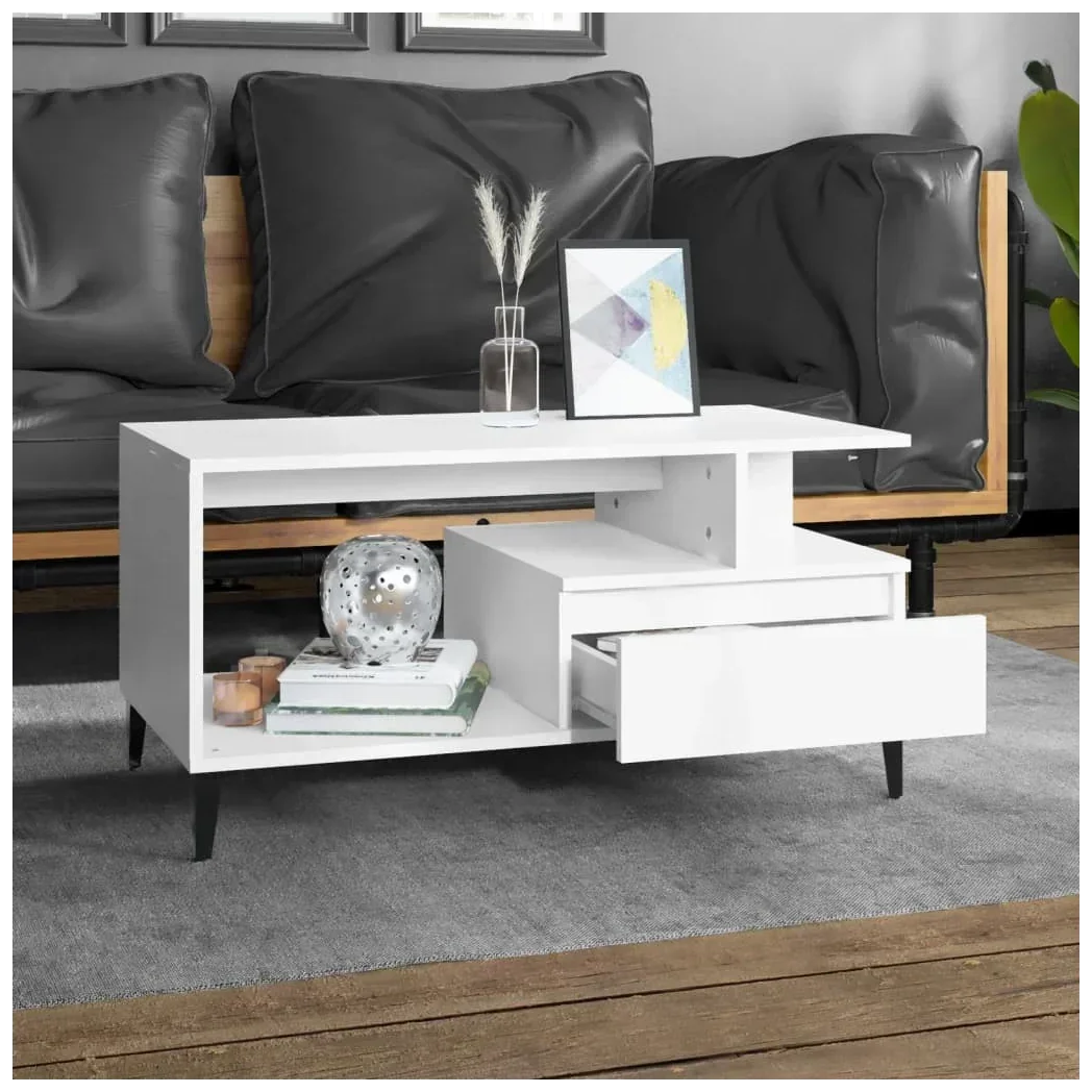 Modern white coffee table with open shelf and drawer, set in stylish living room with black sofa
