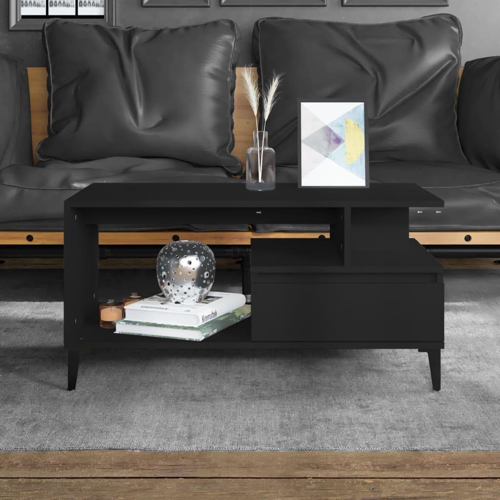 Modern black coffee table with open shelving, decorative items, and storage, set in a stylish living room